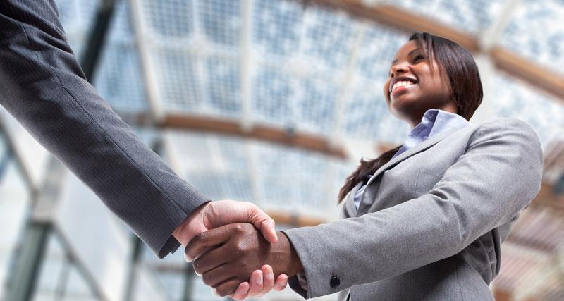 Image of a student shaking hands accepting a job offer